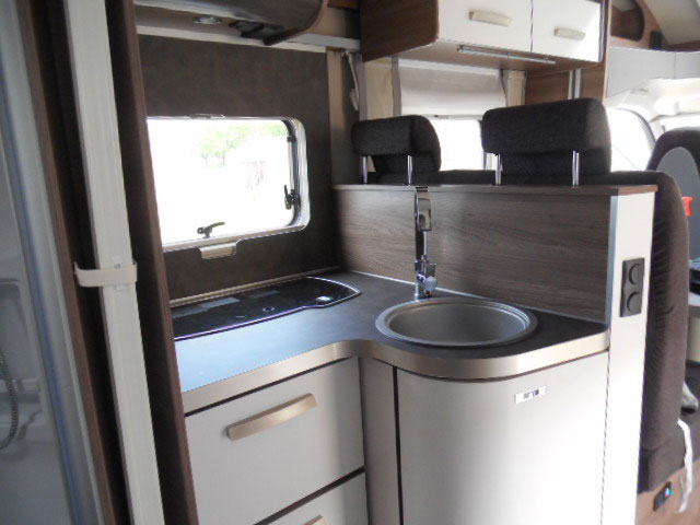 The alcove kitchen is neat and practical with a good sized sink, three ring hob and full height fridge freezer